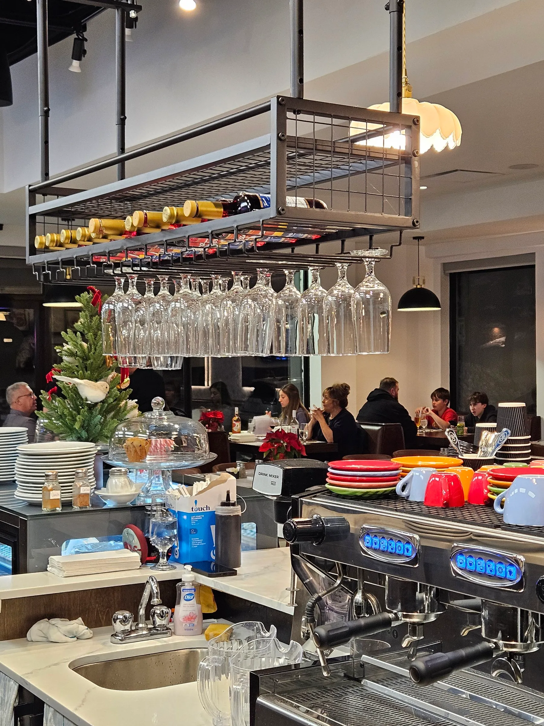 Machine à espresso, tasses colorées et verres au bar de Spanos