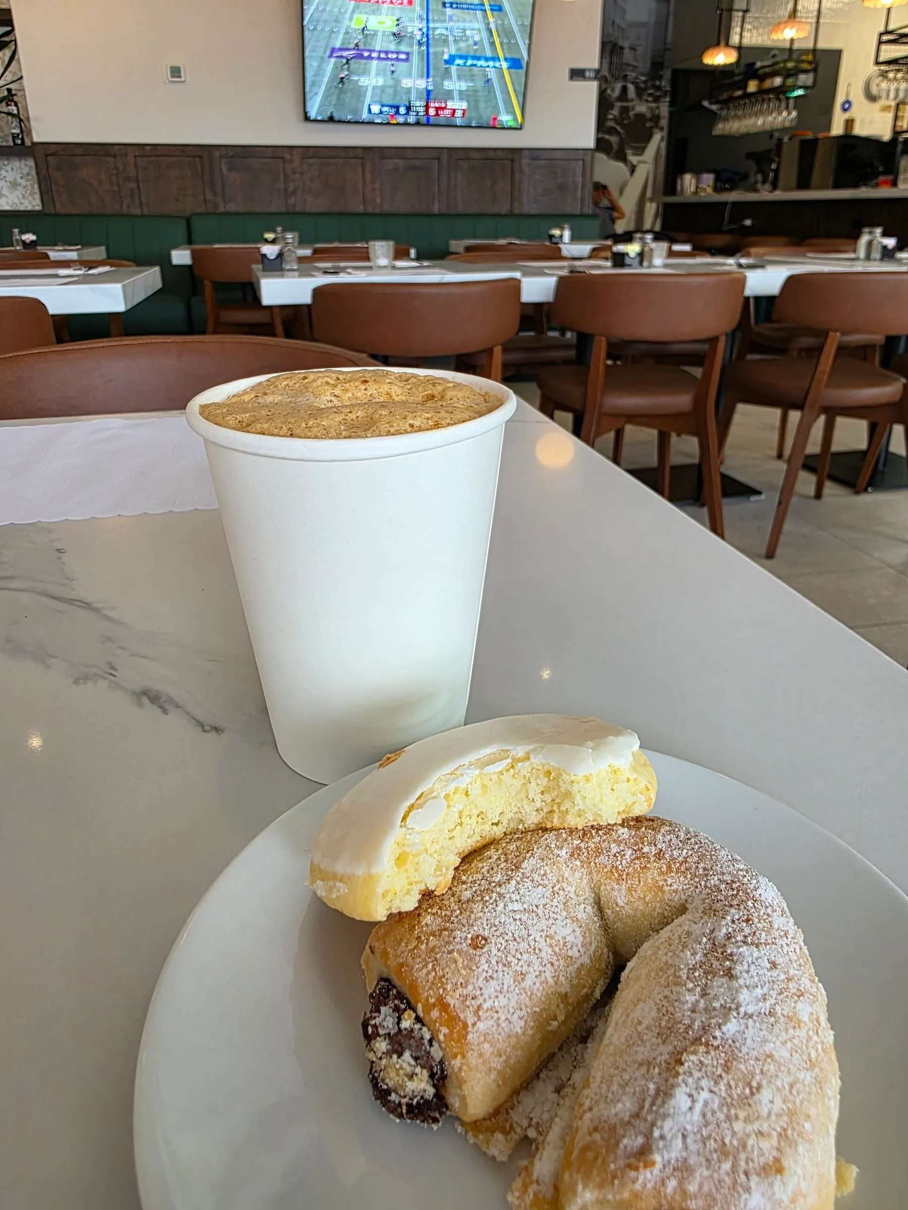 Café dans une tasse pour emporter avec pâtisseries sur une assiette